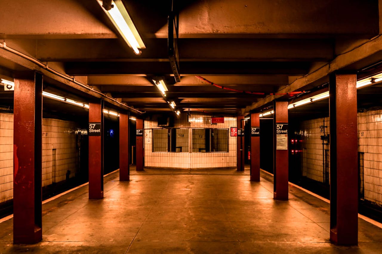 why-choose-me A deserted subway platform in 57th Street Station, New York City, showcasing urban architecture.