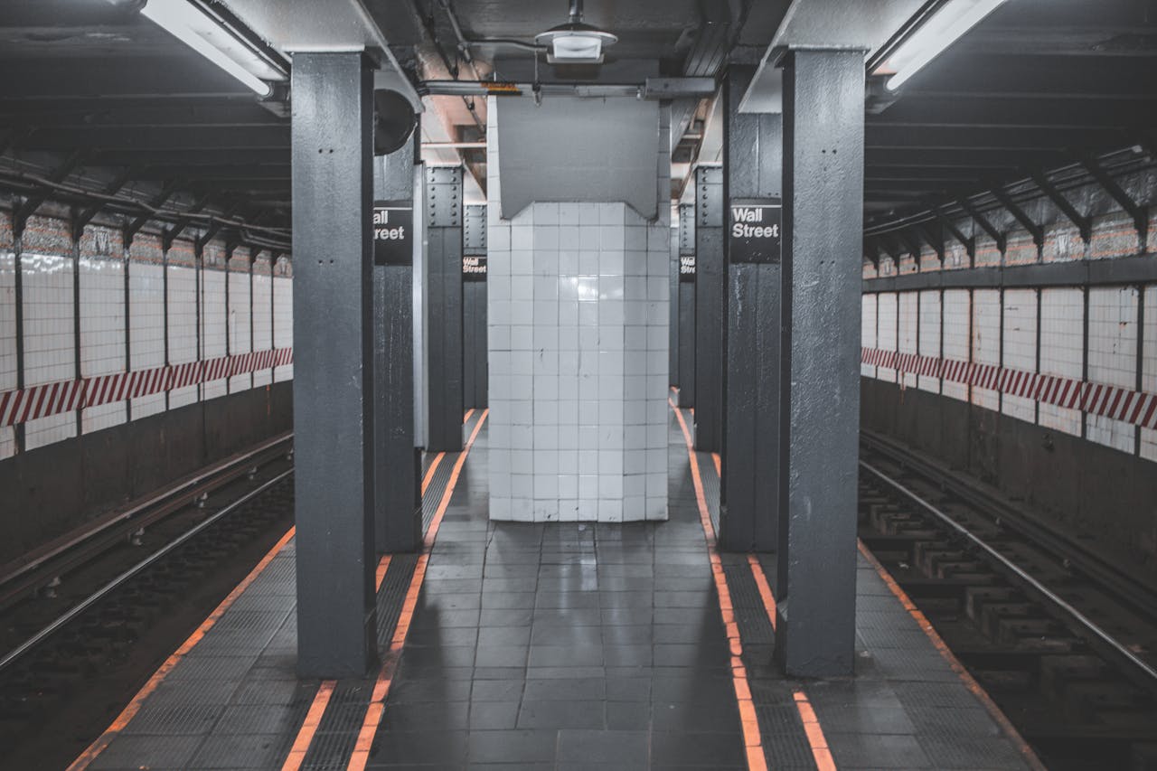 A deserted view of the Wall Street subway station platform in New York City.